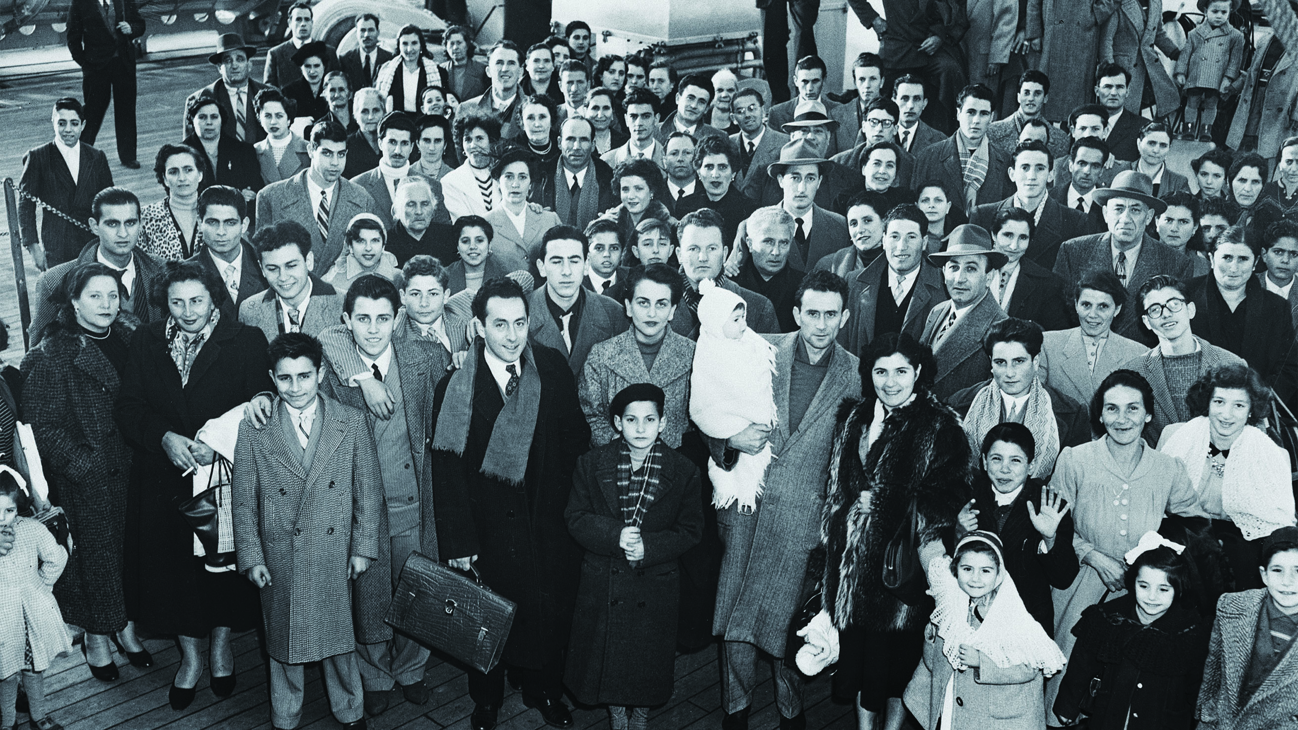 Immigrants arriving in New York from Genoa, Italy, on the deck of the liner SS Conte Giancamano at Christmas 1953. (Bettmann/Getty Images)