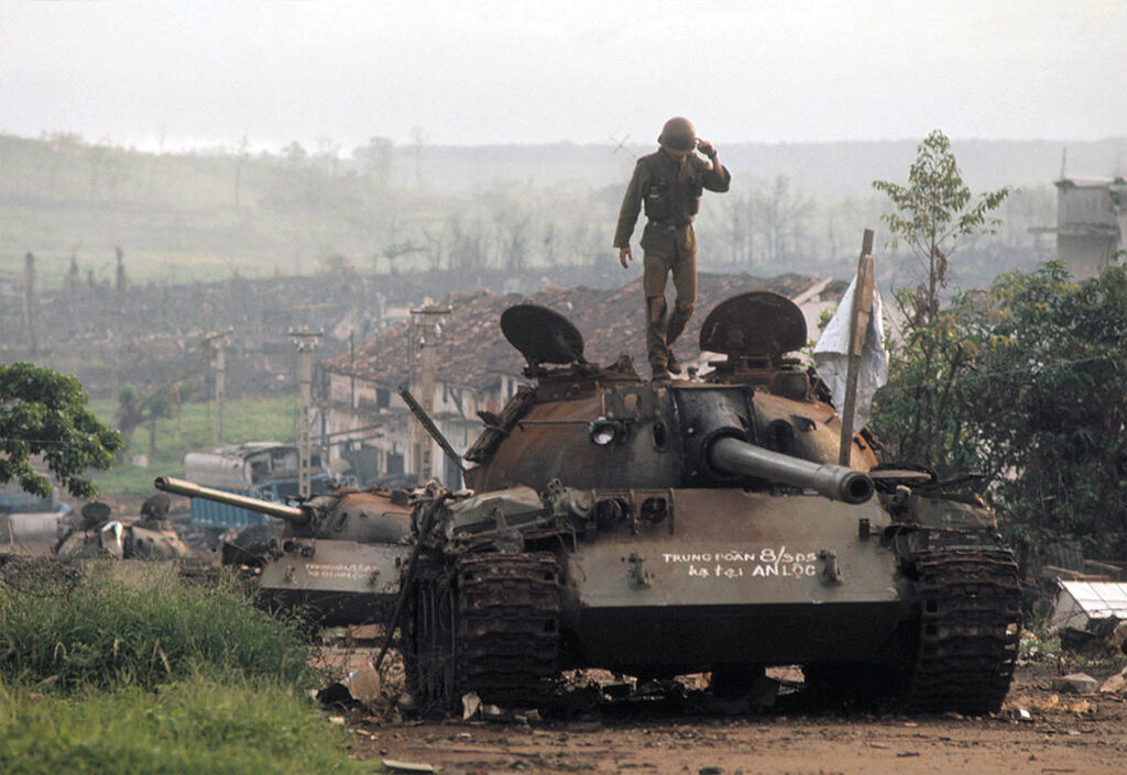 Photo of a South Vietnamese soldier on a tank after the bombing of An-Loc by US forces.