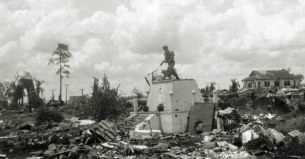 Photo of a monument of Vietnamese government soldier stands almost undamaged amid rubble in center of An Loc, Vietnam on June 14, 1972.