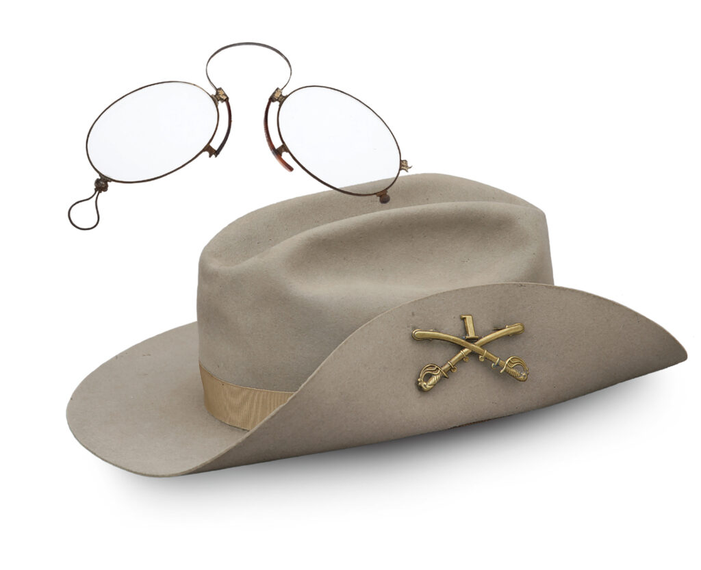 Photo of Theodore Roosevelt's glasses and 1st U.S. Volunteer Cavalry slouch hat.